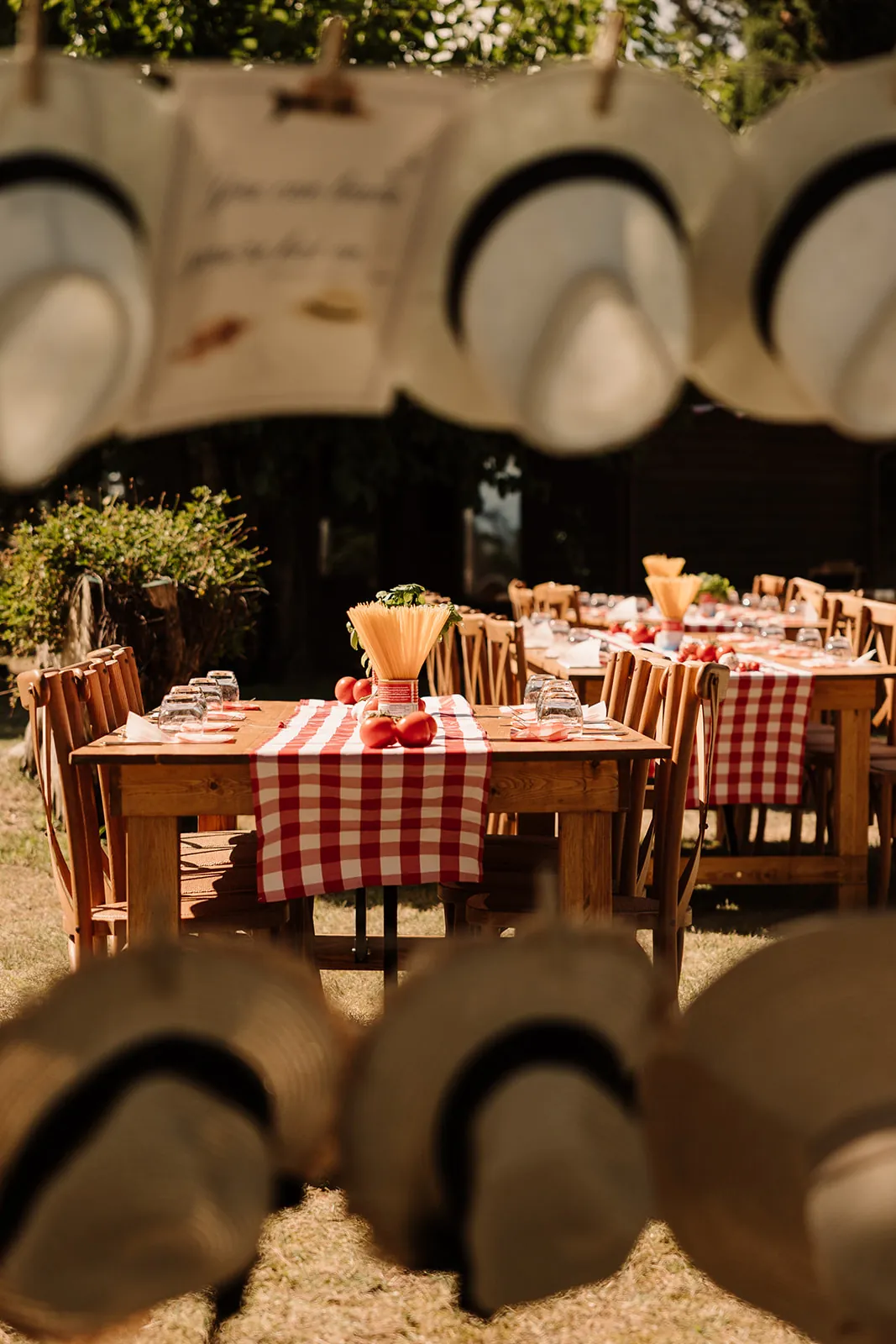 Friday pizza and spritz party with red-checked tables and straw hats
