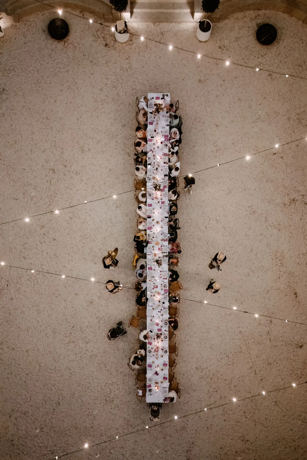 Top-down view of a long wedding table on the court
